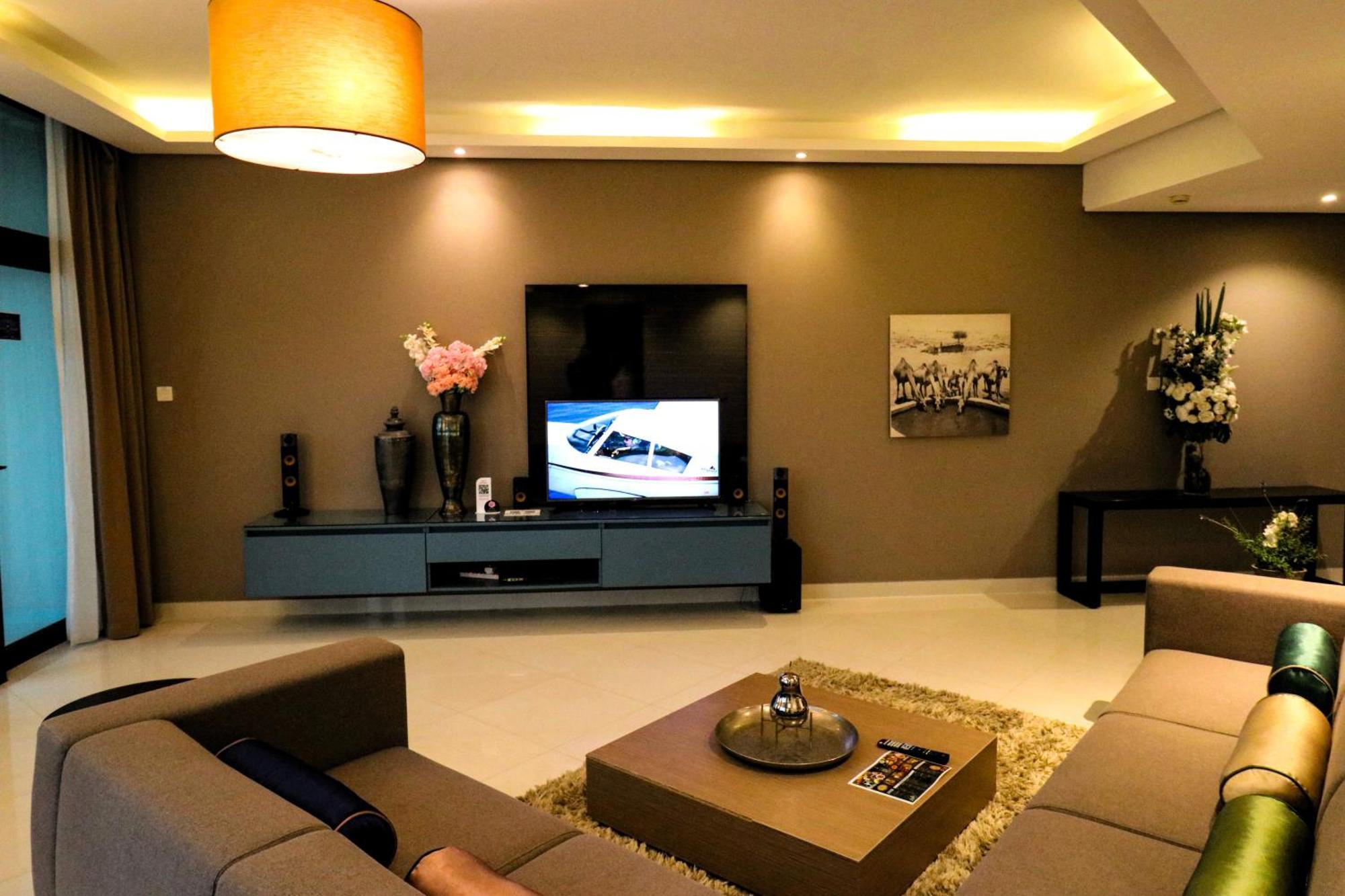 Lagoona Beach Luxury Resort And Spa Манама Екстериор снимка The photo shows a modern living room with a neutral color palette. Key features include:

- A comfortable seating area with a sofa arranged around a coffee table.
- A minimalist coffee table with a decorative item on top.
- A large flat-screen televi